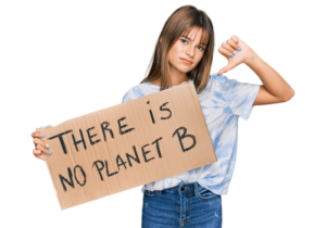 Teenager holding a sign which reads "There is no planet B"